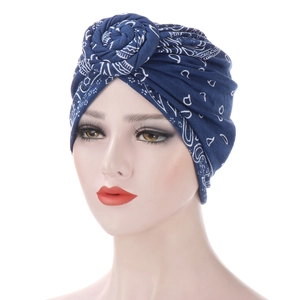 Dark blue paisley turban hat with a top knot design for women shown on a model head