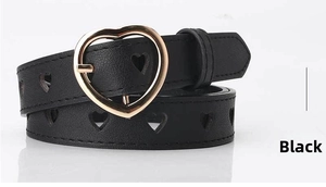 Detail of black belt with heart-shaped cutouts and shiny gold metal buckle