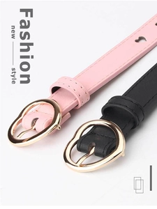 Detail of pink and black women's belts featuring gold heart-shaped metal buckles