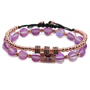Close-up of purple moonstone beads and rose gold cubic zirconia on layered bracelets