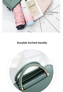 Detail of durable arched handle with gold hardware on dark green handbag