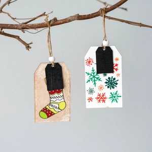 Christmas wooden stocking ornaments with snowflake prints hanging on a natural branch