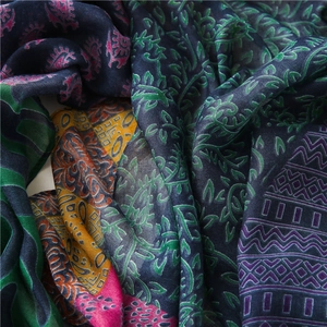 Detail of bohemian ethnic floral print scarf with vibrant green and orange patterns