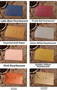 Close-up of small envelopes with heart-shaped clasps in various pearlescent colors