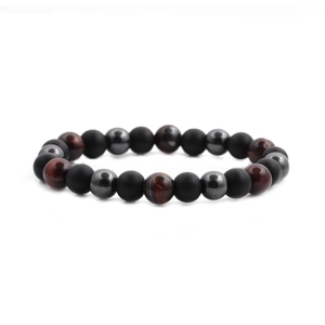 Detailed view of matte black and tiger eye beads on an elastic gemstone bracelet