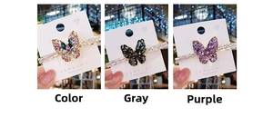 Detailed view of rhinestone butterfly hair clips in colorful, grey, and purple crystal options