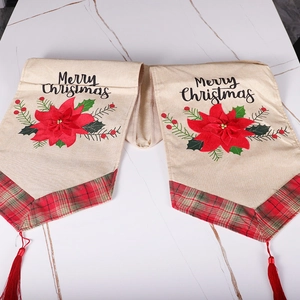 Merry Christmas table runner with red floral print, plaid edges, and red tassels