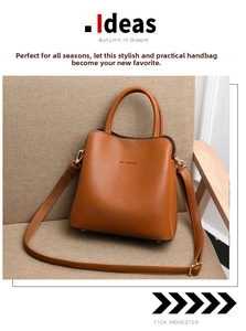 Close-up of caramel lychee-grain leather bucket bag with gold classic logo and metal hardware