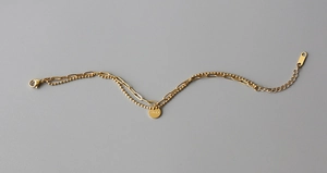 Detail of double-layer gold lucky pendant bracelet with paperclip and ball chains