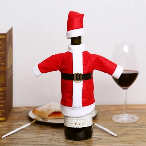Christmas Santa Claus wine bottle cover set with red hat and coat on a wooden table