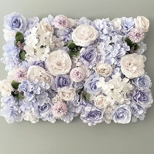 Detail view of artificial flower wall panel with light purple and white roses and hydrangeas