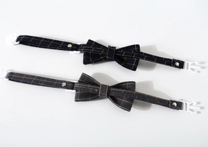 Detail of navy plaid and dark grey herringbone pet collars with durable plastic buckles