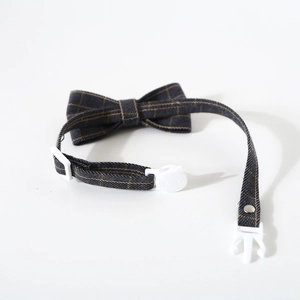 Detailed view of British plaid pet collar with cat-shaped safety buckle and plastic clip