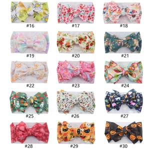 Collection of 15 patterned baby headbands with large bows in various floral and fruit prints
