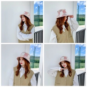 Dettaglio del cappello a secchiello in maglia a quadri rosa, bianco e grigio multicolore