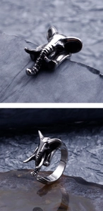 Detailed view of vintage silver elephant ring with punk style texture on dark stone base