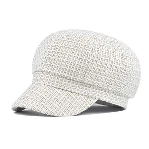 Elegant white tweed newsboy cap with gold silk accents and retro houndstooth pattern