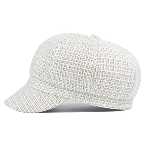 Detail of cream white newsboy cap showing textured tweed fabric and rounded side profile
