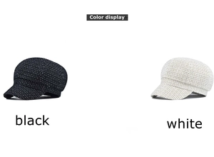 Detail view of tweed newsboy caps showing the black and white textured fabric patterns