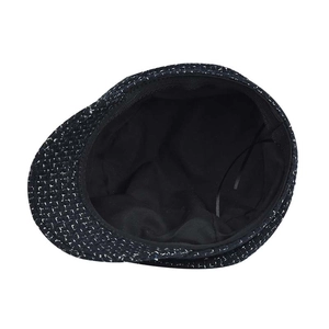 Detail of tweed newsboy cap interior showing black lining and adjustable drawstring