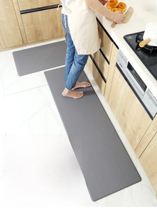 Macro detail of dark grey anti-fatigue kitchen floor mat set with non-slip leather texture