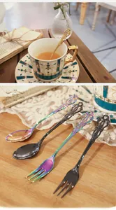 Detailed close-up of vintage embossed stainless steel spoons and forks with hollow handles