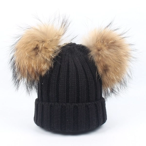 Winter knit hat with double large tan pom-poms in black ribbed fabric for kids