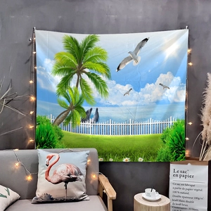 Detail of tropical beach tapestry with dolphins and palms on a cozy bedroom wall