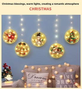 Detail of five warm white LED Christmas window lights with suction cups and festive patterns