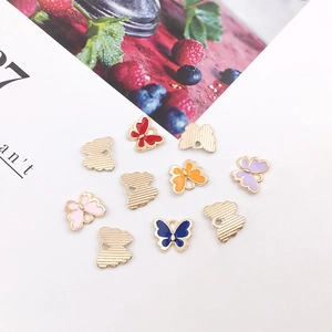 Flat lay of colorful enamel butterfly charms with gold metal edges for DIY jewelry making