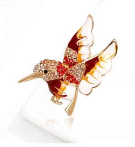 Close-up of colorful hummingbird brooch with enamel finish and sparkling rhinestones