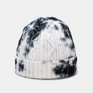 Close-up of the cable knit texture and black and white tie-dye pattern on the beanie