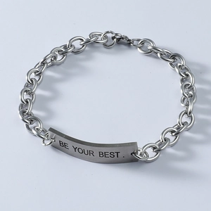 Close-up of silver titanium steel bracelet with engraved 'BE YOUR BEST' curved square plate