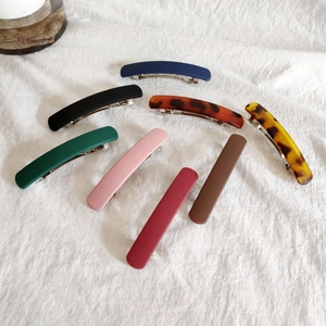 Set of matte acrylic spring hair clips in various solid colors and tortoiseshell patterns