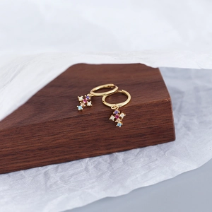 Detail shot of gold cross hoop earrings featuring colorful inlaid zircon crystals