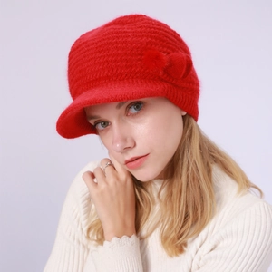Detailansicht der roten Strickmütze mit Schirm, Pelzquaste und warmem Fleece-Futter