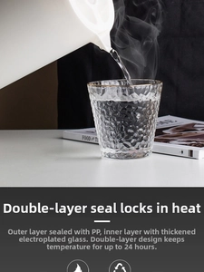 Detail showing hot water pouring from a white Nordic thermal jug into a glass cup with steam