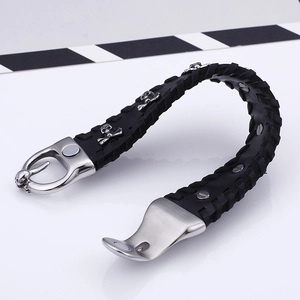 Men's punk braided black leather bracelet with silver skull charms and studded rivets