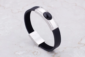 Detail of 316L stainless steel clasp on black braided leather bracelet with black stone