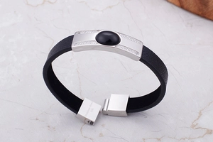 Detail of men's leather bracelet with 316L stainless steel plate and black gemstone