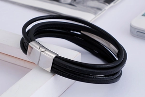 Detailed view of black layered leather bracelet with stainless steel magnetic clasp