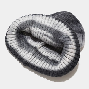Detailed view of grey tie-dye striped knit beanie with thick core-spun yarn texture