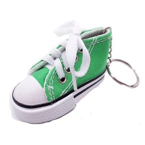 Mini green canvas sneaker keychain pendant with white rubber sole and metal ring