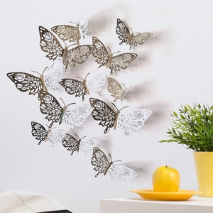 Detailed view of silver and white hollow-out butterfly stickers on a white wall