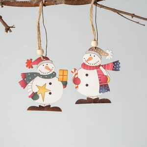Handcrafted wooden snowman Christmas ornaments hanging on branches with rustic jute strings