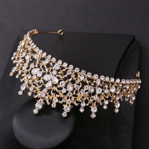 Detail of a Baroque golden bridal crown with intricate floral patterns and sparkling crystals