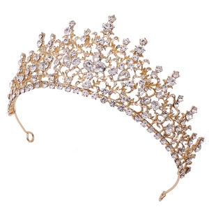 Detail of a golden Baroque bridal crown featuring intricate leaf patterns and clear rhinestones