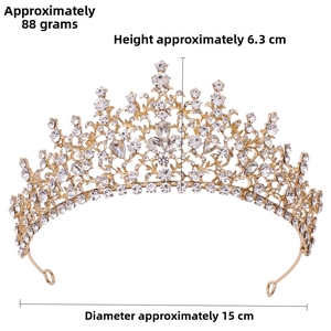 Detailed view of golden Baroque crown featuring crystal rhinestones and filigree design