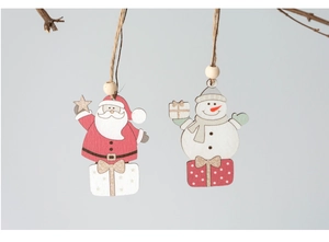 Close-up of painted wooden Santa and Snowman ornaments hanging on natural branches