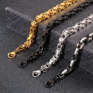 Men's punk skull steel bracelets in gold, silver, and black finishes on textured background